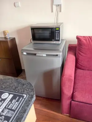 a microwave sitting on top of a counter next to a couch at Апартамент-студио Б4-4-1 Божурленд in Bansko