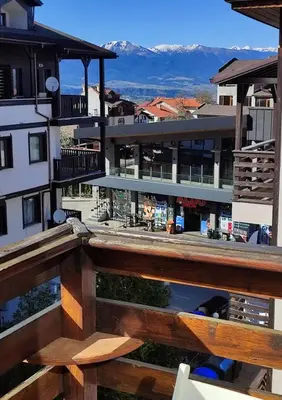 an outdoor deck with a view of a building at GALA 2Bedroom Apartment 200m from Gondola in Bansko