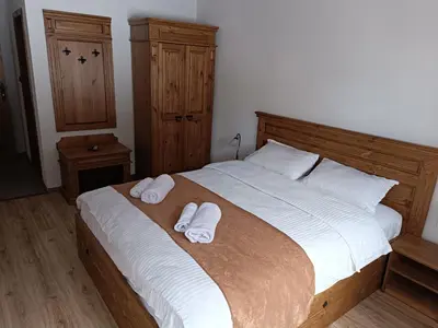 a bedroom with a bed with two towels on it at Villa Victoria in Stoykite