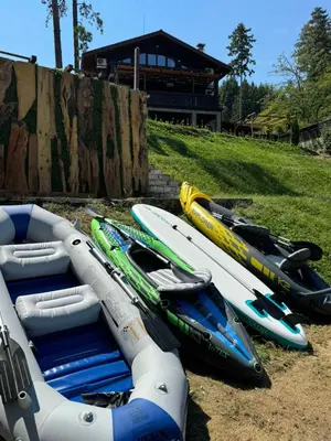 a group of kayaks are lined up on the ground at Villa Iskar Lake Residence by BookVillaBG in Shtarkelovo Gnezdo