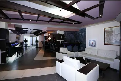 a living room with white couches and a dining room at lux apartament К602 in Bansko