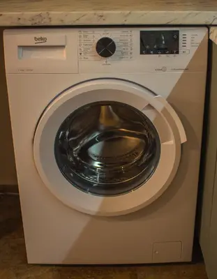 a white washing machine with a door open at EVIAS Apartment in Sandanski