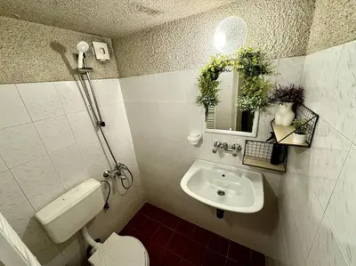a bathroom with a sink and a toilet and a mirror at Sofia Sweet Spot: Central & Cozy in Sofia