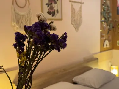 a vase of purple flowers sitting on a table at Cozy and quiet central apartment in Sofia