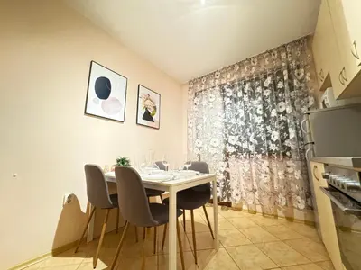 a dining room with a white table and chairs at Cozy and quiet central apartment in Sofia