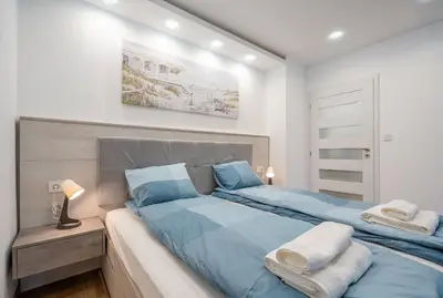 a bedroom with two beds with blue sheets at Harmony Suite in Sofia