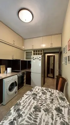 a kitchen with a table and a white refrigerator at Quiet 2 bedrooms downtown apart in Sofia