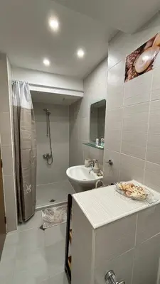 a bathroom with a sink and a shower and a toilet at Garden view top center apart in Sofia