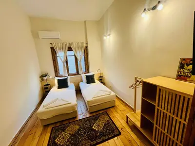 a room with two beds and a crib in it at SKYLER VINTAGE APARTMENTS in Plovdiv