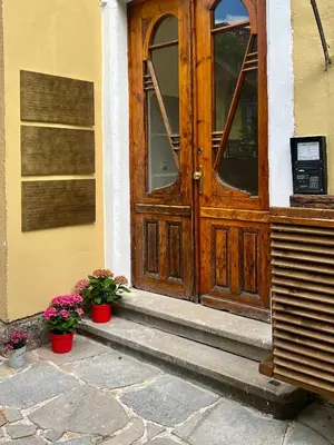a wooden door with two potted plants in front of it at SKYLER VINTAGE APARTMENTS in Plovdiv