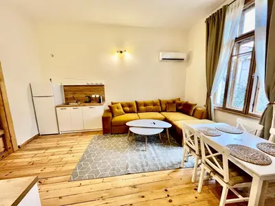 a living room with a couch and a table at SKYLER VINTAGE APARTMENTS in Plovdiv