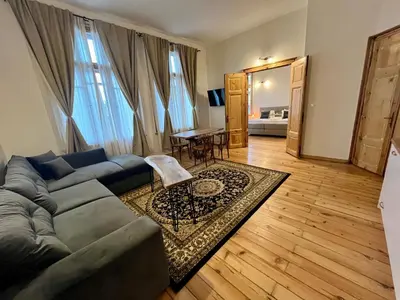 a living room with a couch and a table at SKYLER VINTAGE APARTMENTS in Plovdiv
