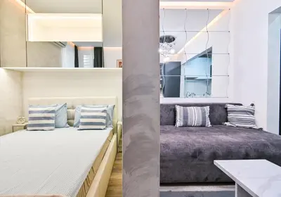 a bedroom with a bed and a couch at Tsar Simeon 65 Studio (With Parking space) in Sofia