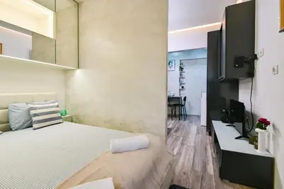 a small bedroom with a bed and a tv at Tsar Simeon 65 Studio (With Parking space) in Sofia