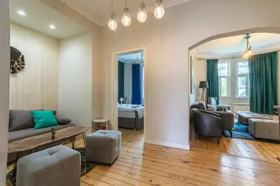 a living room with a couch and a table at 2 Designer Apartments Seconds Away From Тhe Main Street, FREE Parking in Sofia