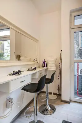 a bathroom with a vanity with two chairs and a mirror at 2 Designer Apartments Seconds Away From Тhe Main Street, FREE Parking in Sofia