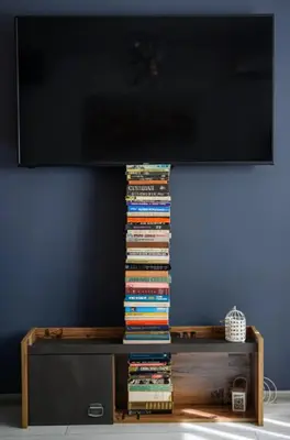 a television on top of a table with a stack of books at 2 Designer Apartments Seconds Away From Тhe Main Street, FREE Parking in Sofia
