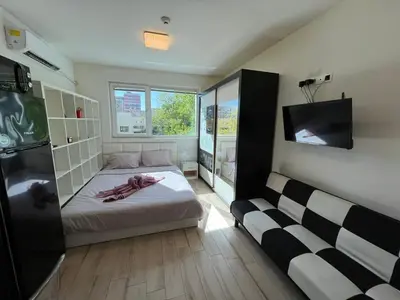 a small bedroom with a bed and a tv at Sao Paolo warm and cosy Studio in lively district in Sofia