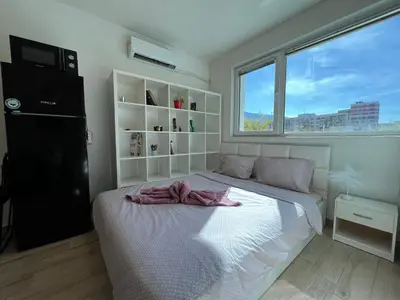 a bedroom with a bed with a towel on it at Sao Paolo warm and cosy Studio in lively district in Sofia