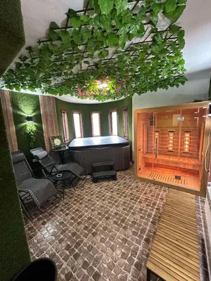 a large room with a large tub in a room with aitating at WhiteBoxApartment in Kyustendil