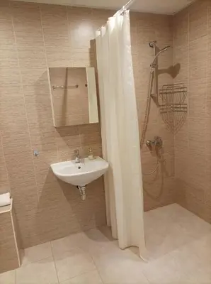 a bathroom with a sink and a shower with a mirror at Terra apartment in Sandanski