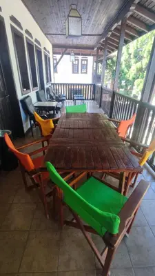a wooden table and chairs on a porch at Aura house in Dolna Banya
