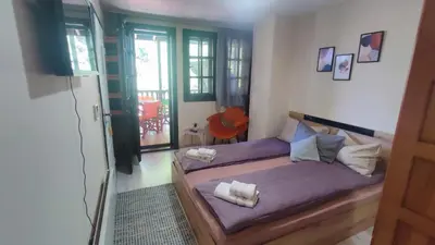 a bedroom with a bed with two pillows on it at Aura house in Dolna Banya