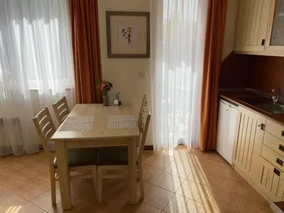 a kitchen with a wooden table and chairs in a room at Pirin Golf private studio in Razlog