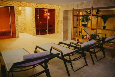 a room with a table and chairs in a room at Хижа Марциганица in Asenovgrad