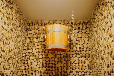 a bathroom with a bucket hanging from the wall at Хижа Марциганица in Asenovgrad
