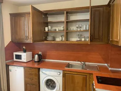 a kitchen with a sink and a microwave at Studio 5 in Pirin Golf in Razlog