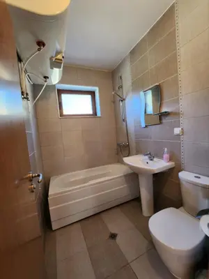 a bathroom with a tub and a toilet and a sink at РЕЛАКС - апартамент 1 in Chepelare