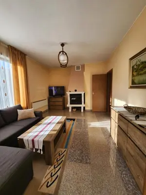 a living room with a couch and a table at РЕЛАКС - апартамент 1 in Chepelare