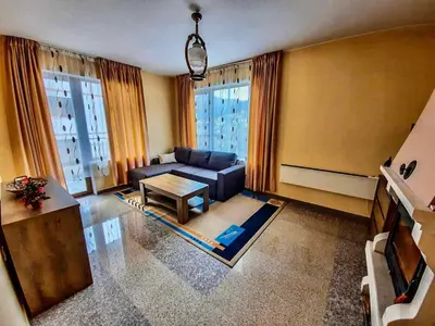 a living room with a couch and a table at РЕЛАКС - апартамент 1 in Chepelare