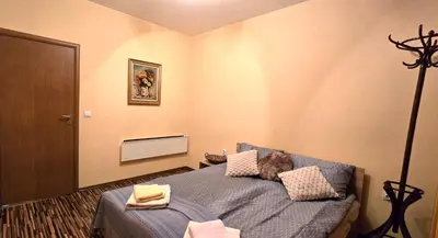 a bedroom with a bed with pillows on it at РЕЛАКС - апартамент 1 in Chepelare