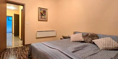 a bedroom with a bed with two pillows on it at РЕЛАКС - апартамент 1 in Chepelare