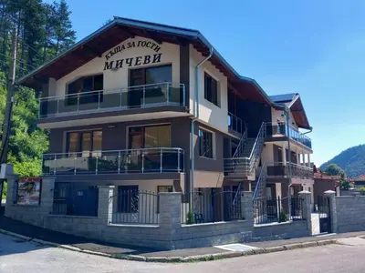 a apartment building with a sign that reads winterfell at Къща за гости МИЧЕВИ in Shipkovo