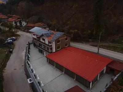 an overhead view of a building with solar panels on it at Къща за гости МИЧЕВИ in Shipkovo