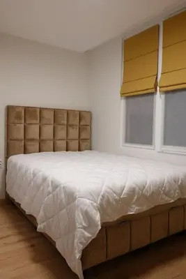 a bedroom with a large bed with a window at Panorama Apartment in Plovdiv