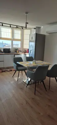 a kitchen with a table and chairs in a room at Panorama Apartment in Plovdiv