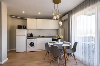 a kitchen and dining room with a table and chairs at The House-Kamenitza Апартамент и релакс зона in Velingrad