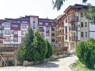 a group of buildings with trees in front of them at Sapphire Mountain 2 in Bansko
