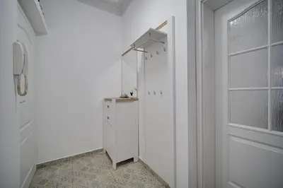 a white hallway with a white door and a lamp at Tulip Dreamland in Sofia