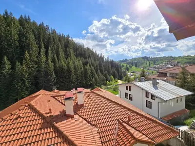 an overhead view of roofs of houses and trees at Вила 5 - Планински перли in Stoykite