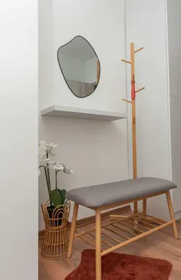 a room with a bench and a mirror at Momento Apartment in Kyustendil