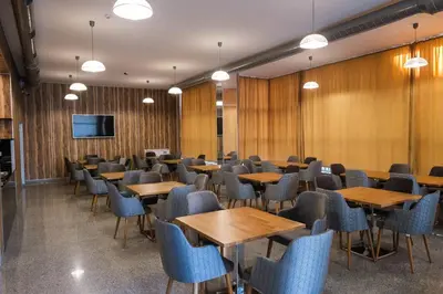 a conference room with tables and chairs and a flat screen tv at HOTEL BAYKO in Plovdiv
