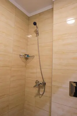 a shower with a shower head in a bathroom at HOTEL BAYKO in Plovdiv