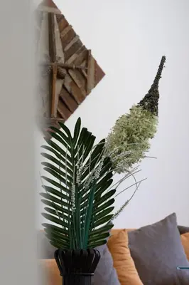 a vase with plants in it on a table at Borche Family Homes in Pamporovo