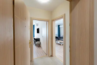 a hallway with a door leading to a living room at Bissera premium apartments in Sofia