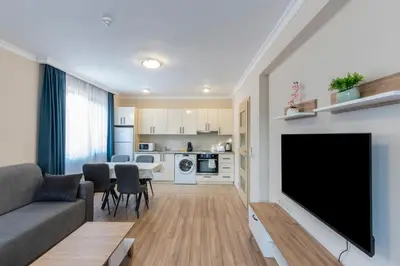 a living room with a large flat screen tv at Bissera premium apartments in Sofia